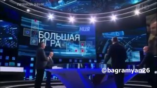 Александр Ионов в зеленом на телеэкране, обсуждающий политику, Тавуш